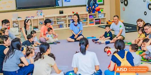 Students seated in a circle on the floor, participating in a relaxed classroom activity with a teacher at Suzhou Foreign Language School.