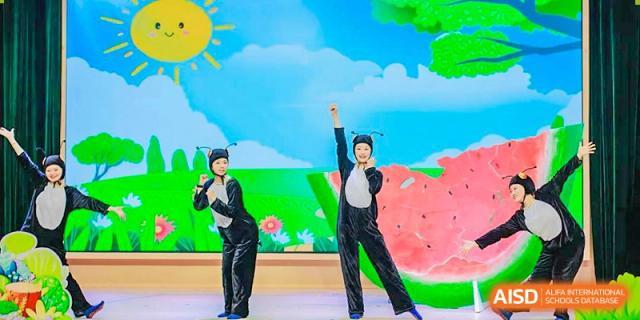 A student striking a dramatic dance pose on stage under bright light, performing at an event at Suzhou Foreign Language School.