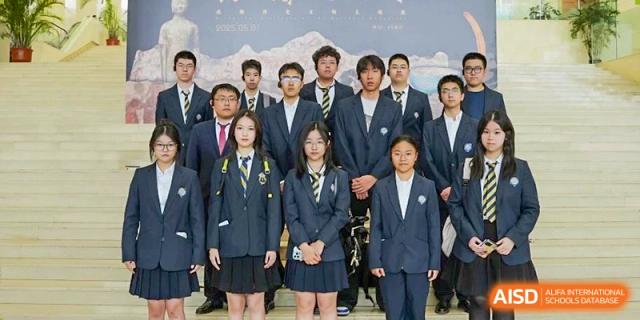 A group of students in formal school uniforms posing for a portrait, representing student leadership or a club at Tianjin Farragut School.