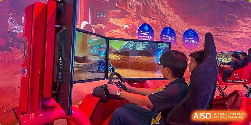 A student is intensely focused on a driving simulation game on a multi-screen setup at Ardingly College Zhongshan (ACZS), showcasing immersive learning or recreational technology and student engagement.