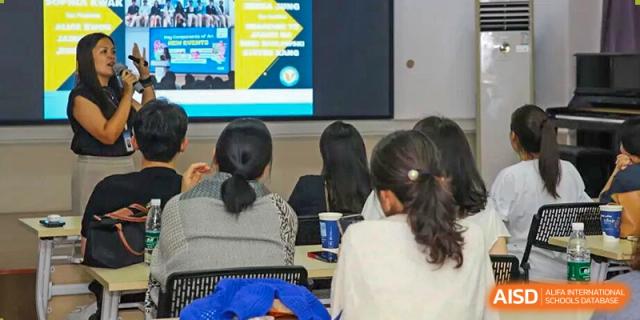 Students sit in a classroom focusing on a digital screen displaying educational slides at Korea International School in Shenzhen.