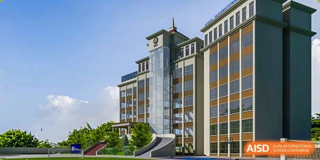 An exterior view showing the modern multi-story glass and stone architecture of the main campus building at Korea International School in Shenzhen.