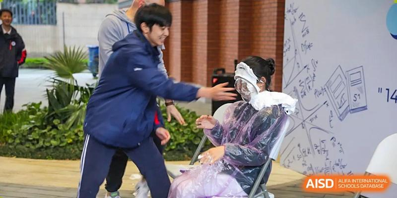 Students participate in a playful pie-in-the-face activity during a school celebration at BASIS International School Wuhan.