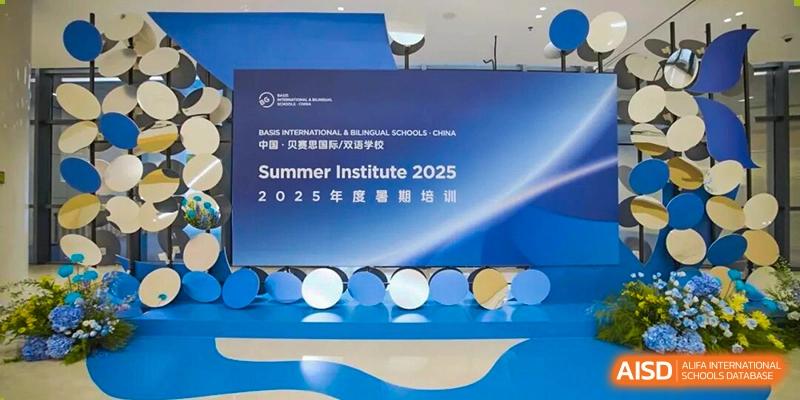 A blue promotional banner for the Summer Institute 2025 featuring a modern geometric design for BASIS International School Wuhan.