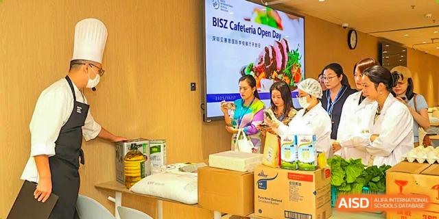 Staff members display food products and information during a Cafeteria Open Day event at BASIS International School Shenzhen.