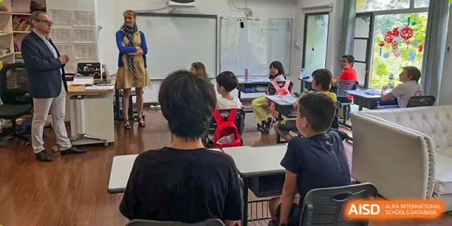 Students sitting at their desks during a lesson, looking toward the front of the classroom at École Française Internationale de Shenzhen(EFIS).