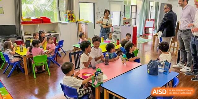 Young children sitting around a colorful table during a group activity in a classroom at École Française Internationale de Shenzhen(EFIS).