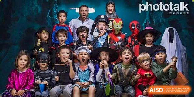 A large group of students in colorful superhero and character costumes pose excitedly at École Française Internationale de Shenzhen(EFIS).
