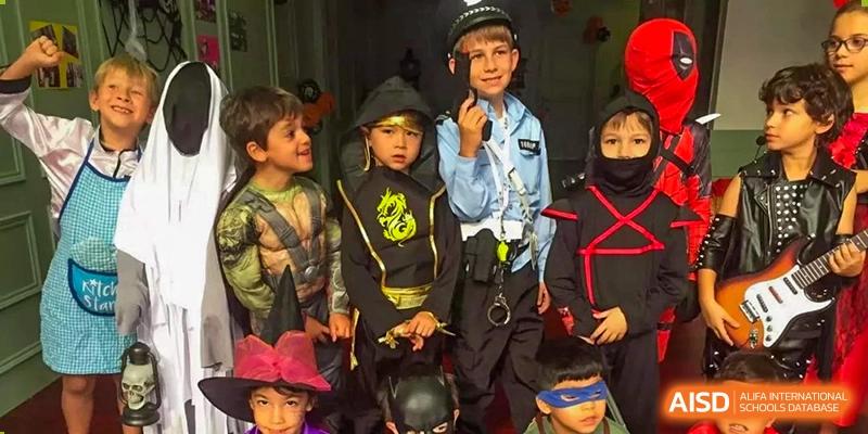 Students dressed as a police officer, ninja, and other characters stand together for a photo at École Française Internationale de Shenzhen(EFIS).