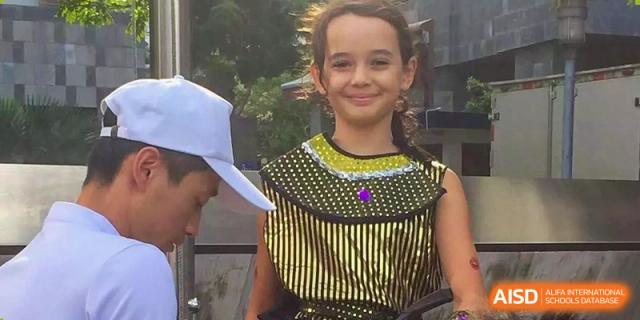 A smiling student dressed in a gold and black Egyptian-themed costume for a school activity at École Française Internationale de Shenzhen(EFIS).