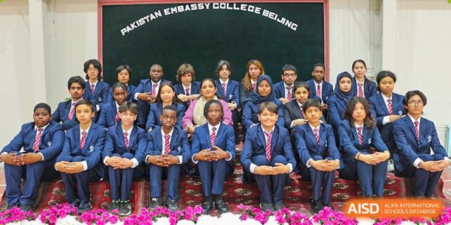 A large group of students from Pakistan Embassy College Beijing in matching blue uniforms seated for a formal photo.