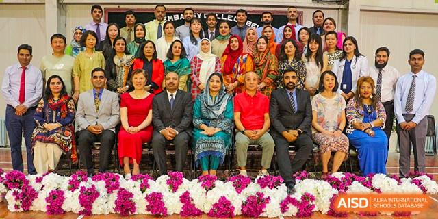 A formal group of teachers and officials from Pakistan Embassy College Beijing seated for a ceremony or special event.