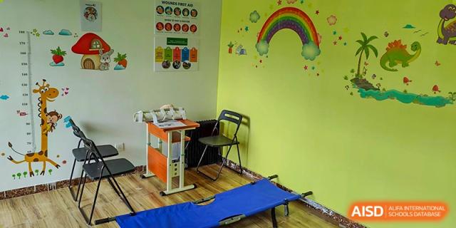A brightly decorated counseling or rest room at Pakistan Embassy College Beijing with a small desk and a colorful mural.