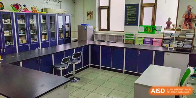 A clean, organized laboratory or classroom space at Pakistan Embassy College Beijing with dark blue cabinets and counters.
