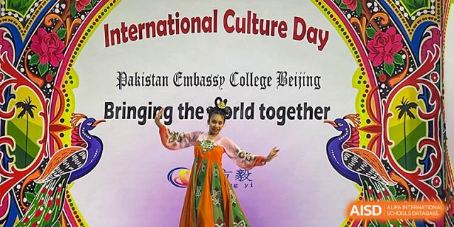 A student from Pakistan Embassy College Beijing performing a traditional dance in an embroidered dress at 'International Culture Day'.