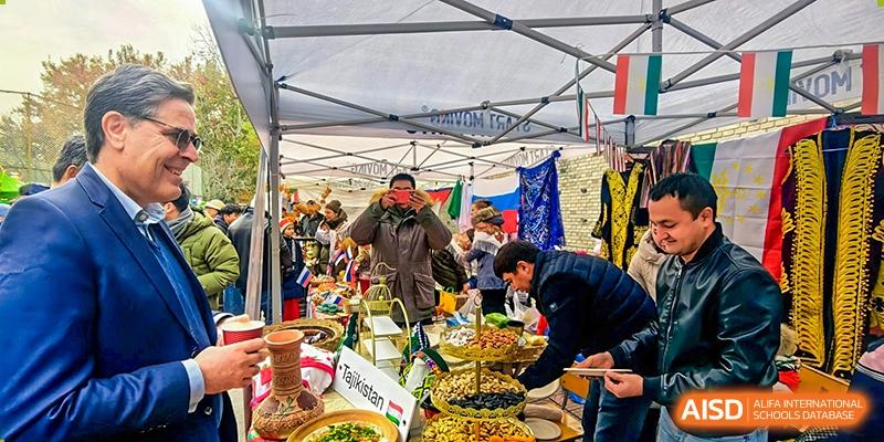 A busy food stall area with people serving and sampling dishes at the 'International Culture Day' event at Pakistan Embassy College Beijing.