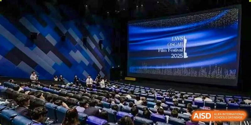 An audience filling a large auditorium for the LWS Oscars Film Festival 2025, with the screen displaying a title slide, Living Word Shanghai.