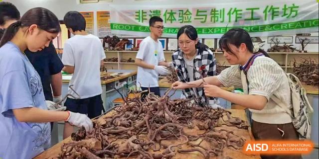Students engage in a hands-on cultural workshop involving natural materials at International Studies Center Of Chongqing Nankai Secondary School.