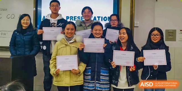 Three students proudly display their merit certificates after a successful presentation at International Studies Center Of Chongqing Nankai Secondary School.