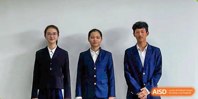 Three students standing together in matching professional navy blue school blazers and white shirts at Shenzhen Senior High School International Division.