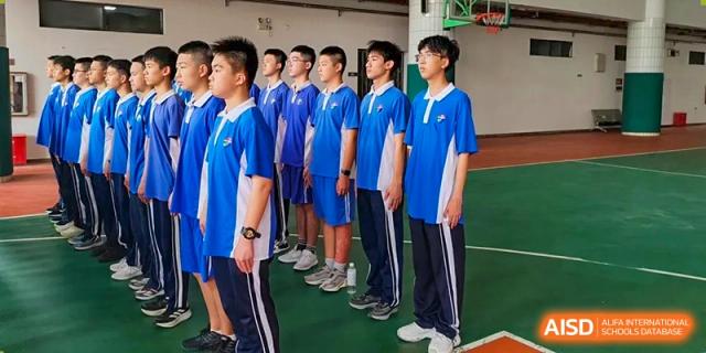 Close-up of students lined up in blue uniforms during an outdoor school assembly at Shenzhen Senior High School International Division.