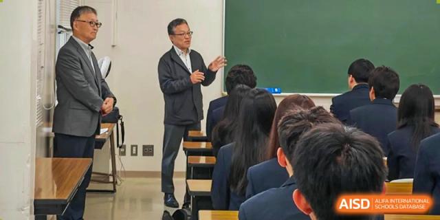 A teacher in a black jacket stands at the front of a classroom lecturing to students at Wuxi Foreign Language School International Curriculum Center.