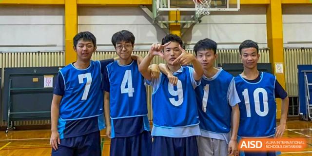 Students in blue jerseys with numbers 4 and 9 posing for a photo together at Wuxi Foreign Language School International Curriculum Center.