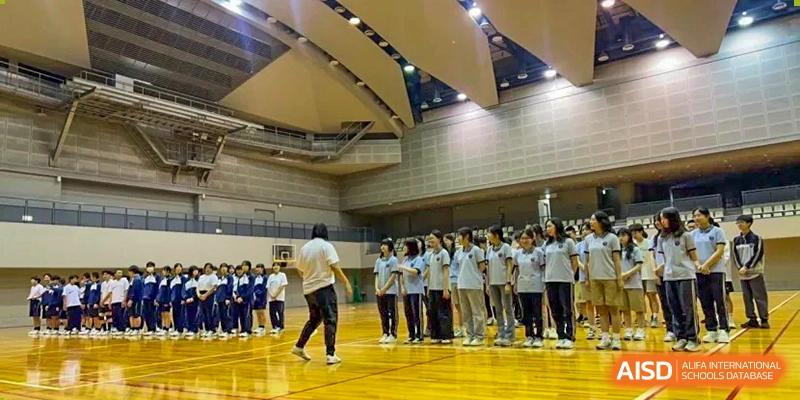 A wide shot of students in a large gymnasium lined up for a sports activity at Wuxi Foreign Language School International Curriculum Center.