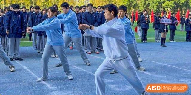 A student in a white tracksuit performs a martial arts demonstration at Wuxi Foreign Language School International Curriculum Center.