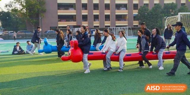 Students participate in a fun team-building race on inflatable toys at Wuxi Foreign Language School International Curriculum Center.
