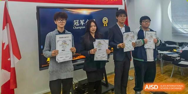 Three students in formal blazers proudly display their academic achievement certificates on stage at XuZhou No.3 Middle School.