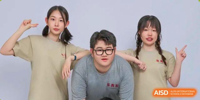 A group of young students poses together for a playful and casual portrait in a bright room at XuZhou No.3 Middle School.