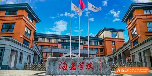 The school's name is engraved on a large stone monument standing before the main flagpole area at Beijing International Bilingual Academy Guiyang.
