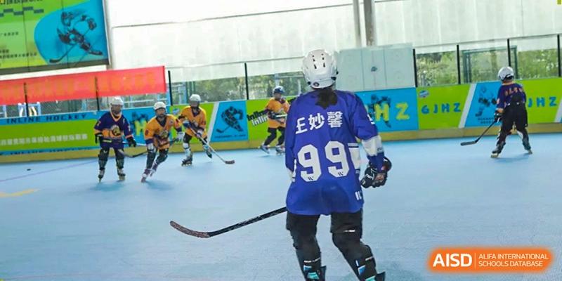 A student wearing a blue jersey with the number 99 skates across the indoor rink at Beijing International Bilingual Academy Guiyang.