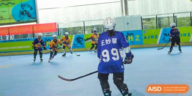 A student wearing a blue jersey with the number 99 skates across the indoor rink at Beijing International Bilingual Academy Guiyang.