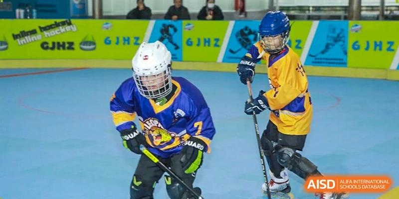 A focused hockey player in full protective gear prepares for a drill on the rink at Beijing International Bilingual Academy Guiyang.