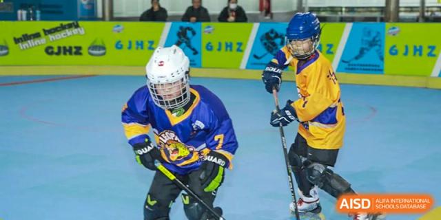 A focused hockey player in full protective gear prepares for a drill on the rink at Beijing International Bilingual Academy Guiyang.