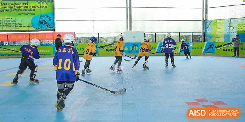 Several students in yellow and blue uniforms practice their skating and puck handling skills on the rink at Beijing International Bilingual Academy Guiyang.
