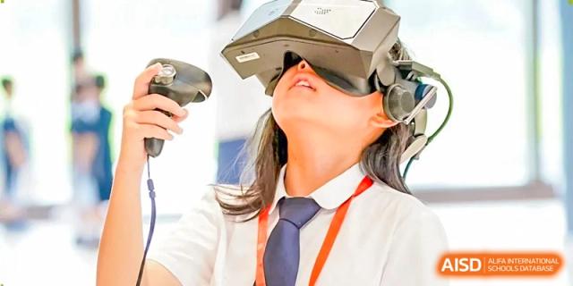 A student experiences immersive learning while wearing a virtual reality headset during a technology class at Benenden Bilingual School Guangzhou