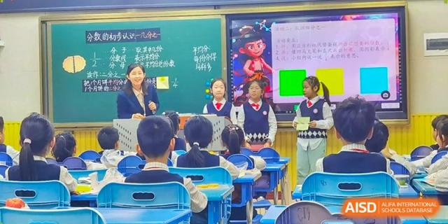 Students stand at the front of a classroom decorated with colorful posters to give a group presentation at Harbin Meijia Foreign Language School.