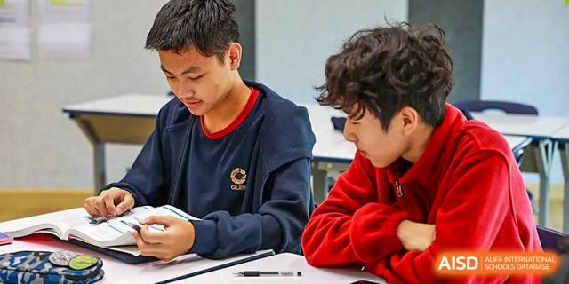 Two students sitting together and working collaboratively on a project during a study session at Guangzhou ULink International School.