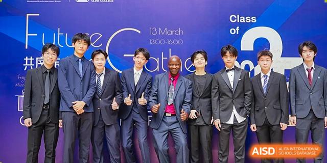 Students and staff in formal attire posing in front of a purple event backdrop for a school gathering at Guangzhou ULink International School.