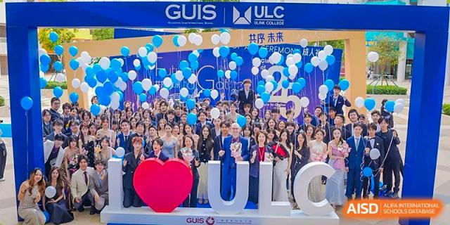 A large crowd of students celebrating with blue and white balloons during a festive campus event or ceremony at Guangzhou ULink International School.