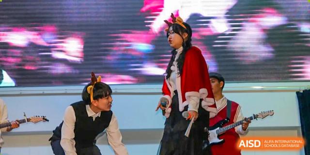 Students perform a dramatic skit in festive costumes on stage during a school holiday event at Korean International School In Beijing.