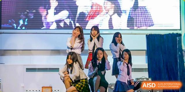 A student dance group poses in a formation during a musical performance at Korean International School In Beijing.