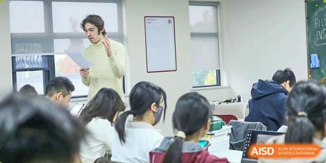 Students in a modern classroom listen attentively to a lecture being delivered by an instructor at Griffin International Academy.