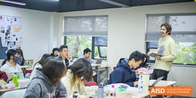 Students focus on their work while sitting at desks in a bright and contemporary learning space at Griffin International Academy.