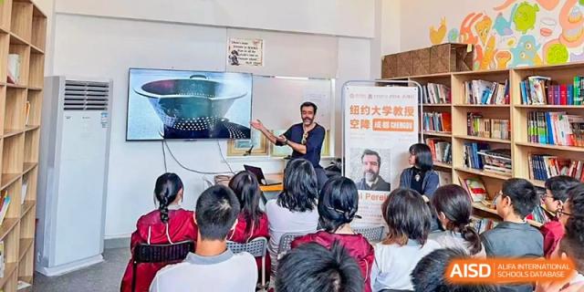 An educator stands at the front of a classroom and leads an interactive presentation for students at Griffin International Academy.