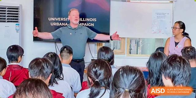A male instructor gives an enthusiastic presentation to a classroom of students during a seminar at Griffin International Academy.