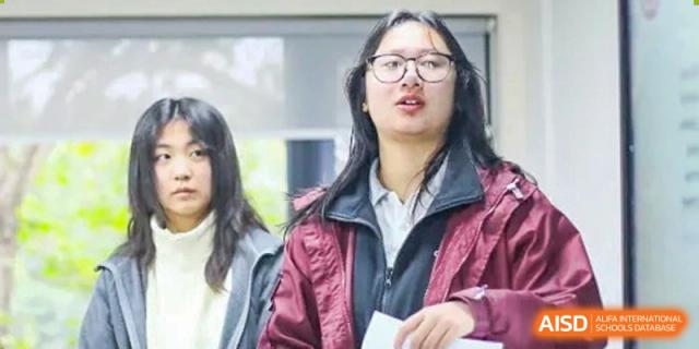 Students focus intently on their individual work while seated at desks in a contemporary and open learning space at Griffin International Academy.